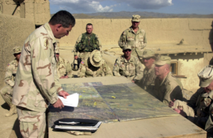 US Army (USA) Lieutenant Colonel (LTC) Allen (left), Commander of the Gardez Compound, provides a situation briefing for the Command Sergeant Major of the Army (CSMA) Jack Tilley (seated center), during the CSMA visit at the Gardez Compound, Afghanistan, during Operation ENDURING FREEDOM (picryl.com)