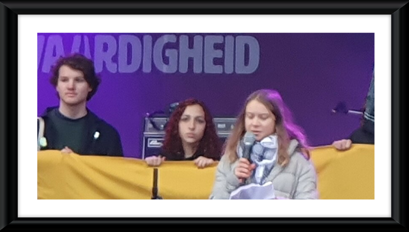 Thunberg wearing a keffiyeh in solidarity with Palestine at an event in Amsterdam in 2023- Wikipedia