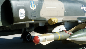 A GBU-15 glide bomb mounted on the wing pylon of an F-4 Phantom II aircraft at White Sands Missile Range- https://picryl.com/