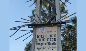 Sign on a power pole that warns of the danger of being hit by high electrical voltage in Jerusalem - wikipedia