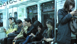 People engaging with their phones on the Seoul Metro - 5166351572 4e33242d3e o.jpg - Wikimedia Commons