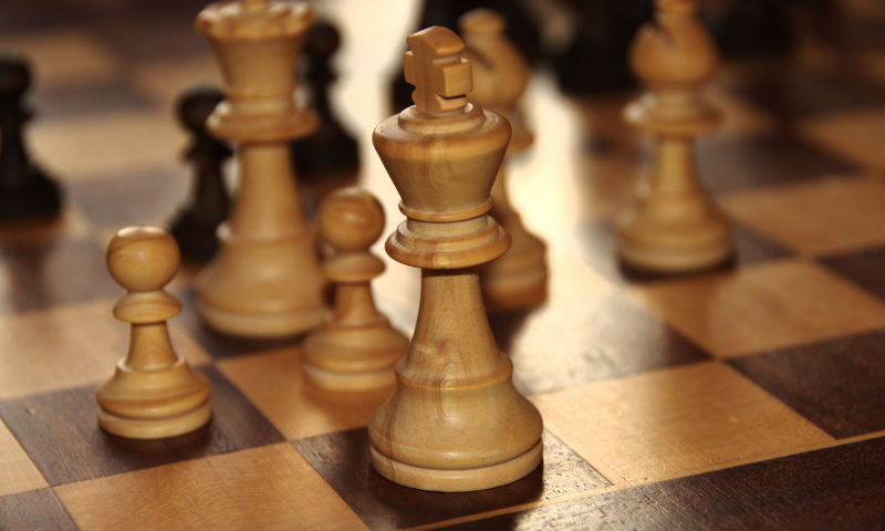 close up of a white king on a chess board- WIKIPEDIA