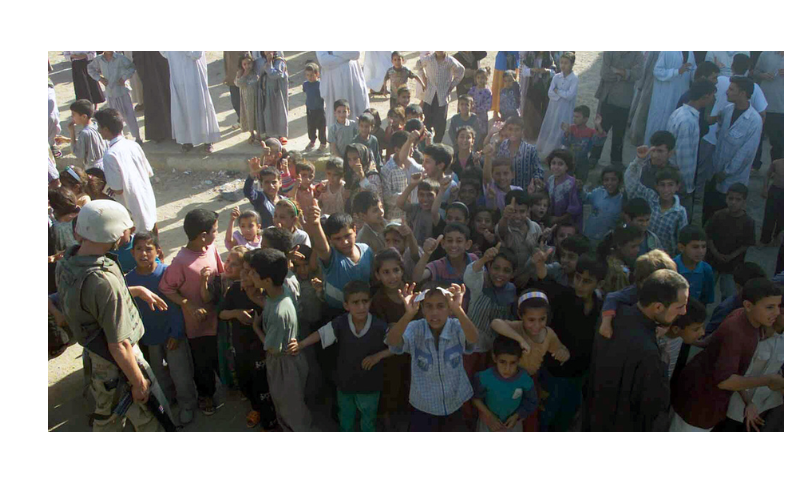 Newly liberated Iraqi civilians and crowds of children gather in the streets and eagerly greet US Military personnel in the town of Qalat Sukkar, Iraq, during Operation IRAQI FREEDOM - PICRYL 
