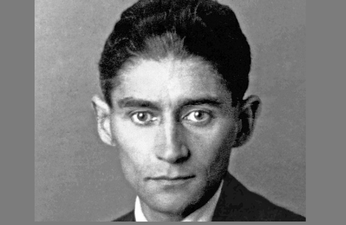 Black-and-white photograph of Kafka as a young man with dark hair in a formal suit (Wikipedia)