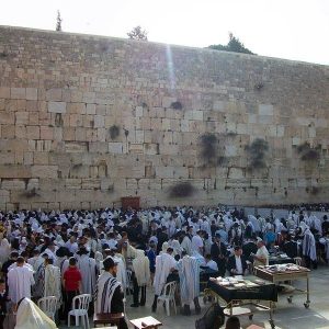  Jewish men praying on their side of the partition at the Western Wall in Jerusalem on a morning during Passover (Source: Wikipedia)